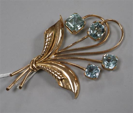 A 14ct gold and aquamarine set foliate spray brooch, 72mm.